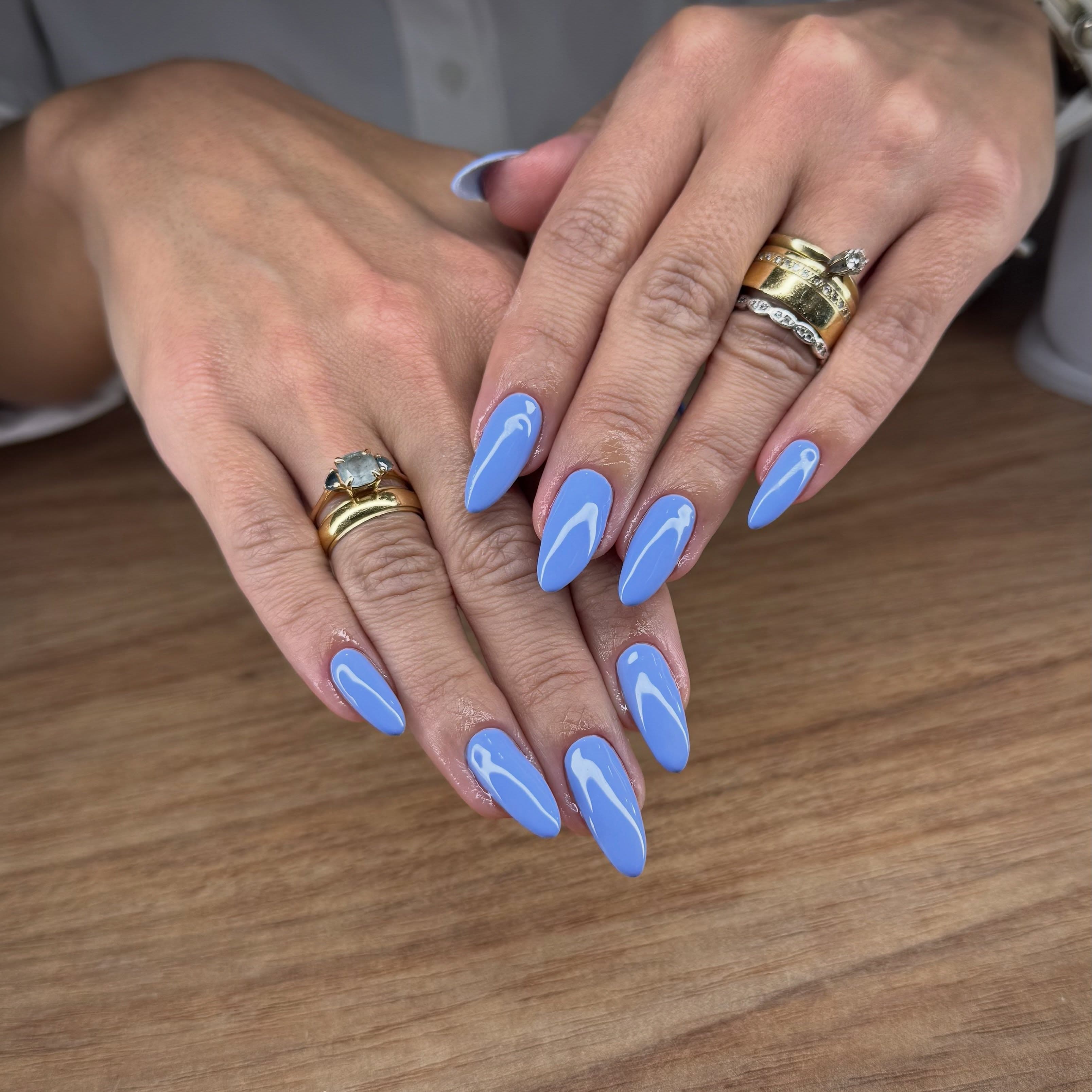 Unhas longas amendoadas em azul claro, esmaltação em gel